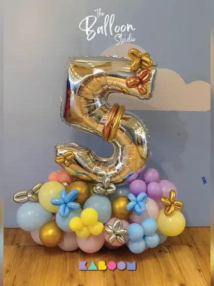 Wrapped in joy! This beautiful pastel and gold balloon bouquet for a fifth birthday is a perfect example of our creative and custom designs.