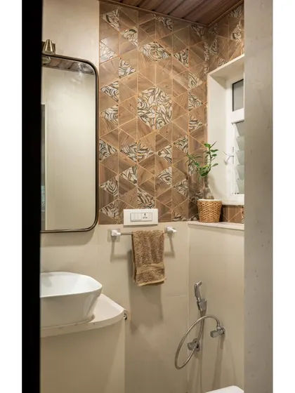 The powder room renovation, featuring textured geometric tiles on the highlight wall and a wooden ceiling to add warmth and character to the small but challenging space.