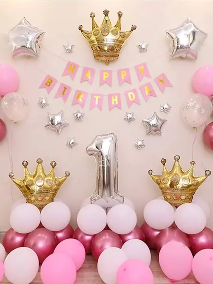 The same princess-themed first birthday setup, providing a clear view of the balloon arrangement and foil accents.