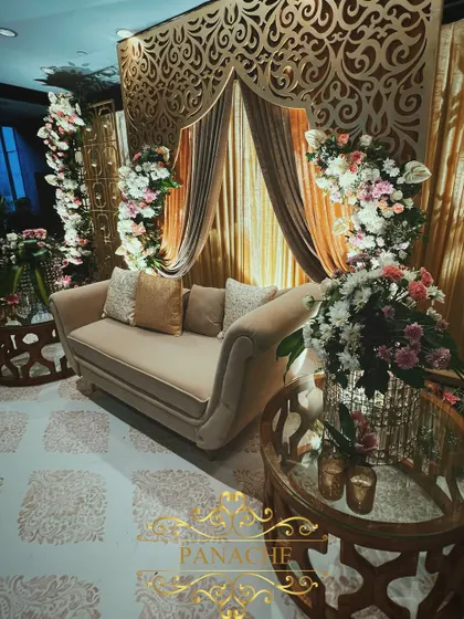 A side angle of the elegant Roka stage, highlighting the plush seating and detailed floral arrangements. The design provides a beautiful setting for the couple's first official ceremony.