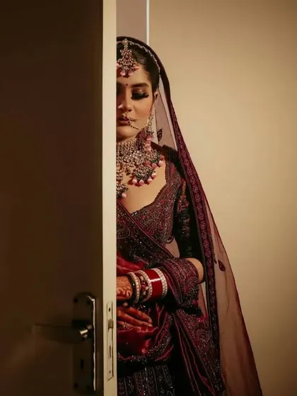 A creative bridal portrait, with the bride peeking from behind a door. This shot creates a sense of anticipation and mystery, adding an artistic touch to the bridal gallery.