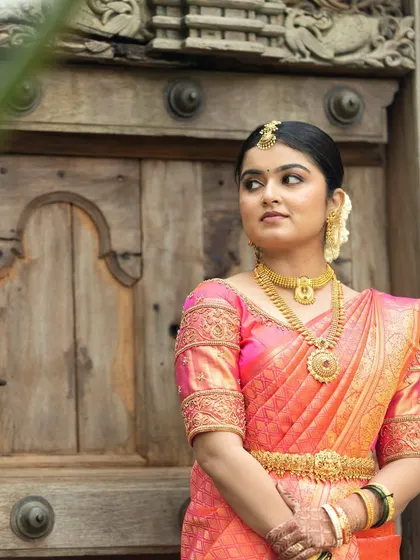 Shubha looking serene and beautiful on her wedding day. The makeup is subtle, with an emphasis on clean skin and defined features, letting her natural beauty shine.