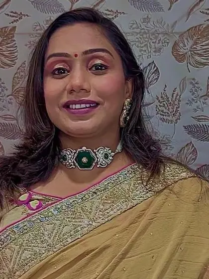 A happy client wearing my emerald green choker. It's a versatile piece that can be styled with both traditional and contemporary outfits for a touch of elegance.