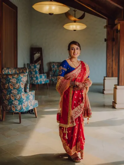 A bride in a traditional Maharashtrian sari, her happy smile lighting up the room.