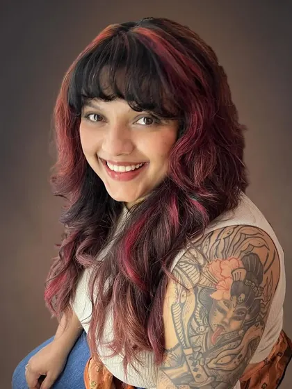 The layers and bangs create a modern, edgy look.