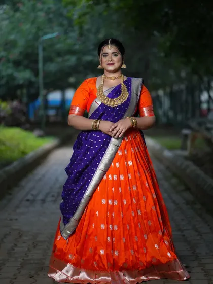 A vibrant custom half saree in orange and royal blue for Navaratri Day 4.