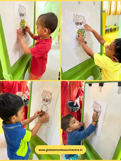 Another view of the 'Dress Up' activity, highlighting the children's concentration and the fine motor control required to handle the small paper pieces.