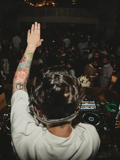 Greeting the crowd from the DJ booth at a "blur hour" event. I make sure to connect with the audience, whether it's a crowd of thousands or an intimate club.