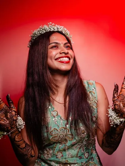 Tradition meets creativity in this photo. This happy bride chose a full coverage design but paired it with a modern outfit and a floral crown for a fresh look.