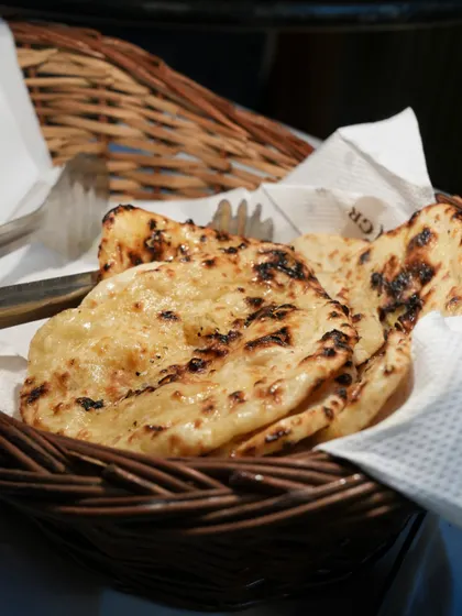 A basket of soft, freshly made rotis, the perfect accompaniment to our wide range of Indian curries.