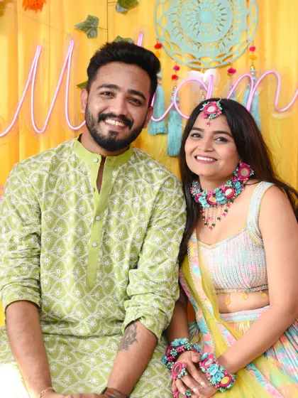 A beautiful, smiling portrait of the couple, capturing the joy of their pre-wedding festivities.