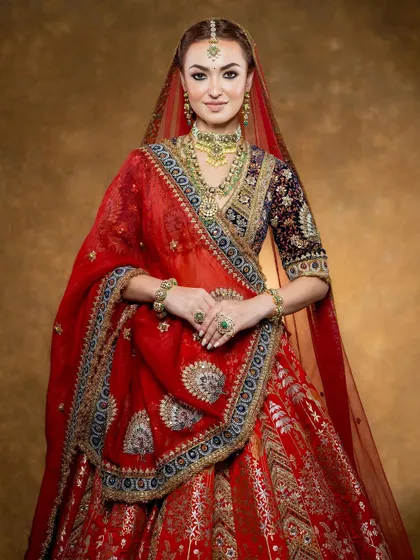 A three-quarter shot that highlights the detailed craftsmanship and layering of a traditional bridal outfit, perfect for lookbook storytelling.