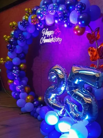 The 25th anniversary balloon circle with deep blue and purple lighting.