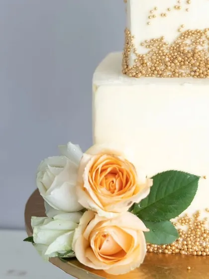 Another angle of the square wedding cake, highlighting the beautiful contrast between the sharp edges and the soft floral arrangements.