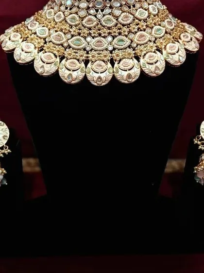 A beautiful meenakari choker with matching jhumkas. The enamel work is detailed and colorful, perfect for adding a pop of personality to your look.