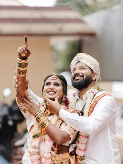 Another angle of the happy couple, Sumitha and Navjyoth, pointing towards their future together. It's a hopeful and optimistic wedding portrait.