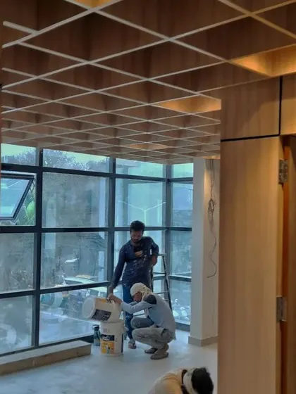 Another behind-the-scenes view of the institute's welcome space. You can see our team at work, bringing the vision of a transparent, welcoming, and rich interior to life against the backdrop of large glass windows.
