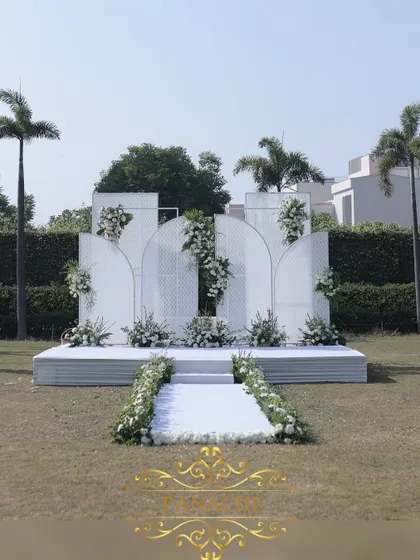 A wider view of the outdoor stage, showing its placement on the lush green lawn of the Jaypee resort.