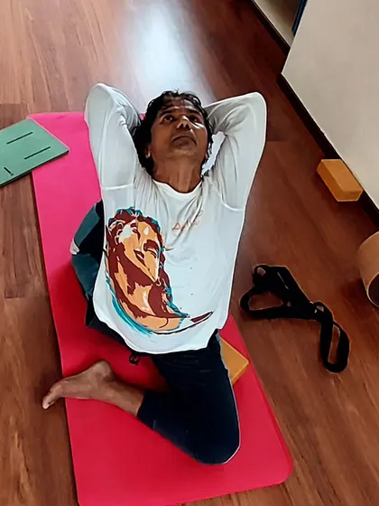 A practitioner holds Supta Virasana, a reclining hero pose that provides a deep stretch for the quadriceps and opens the chest. This posture encourages you to stretch your limits and elevate your inner peace.