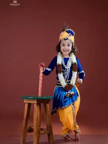 A smiling little Krishna, ready to play his flute. The joy on his face is what makes these shoots so special.