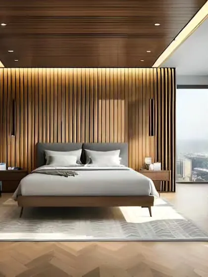 This bedroom features a stunning wood-paneled accent wall with integrated lighting. The design includes two separate desk spaces, making it an ideal setup for a couple working from home.