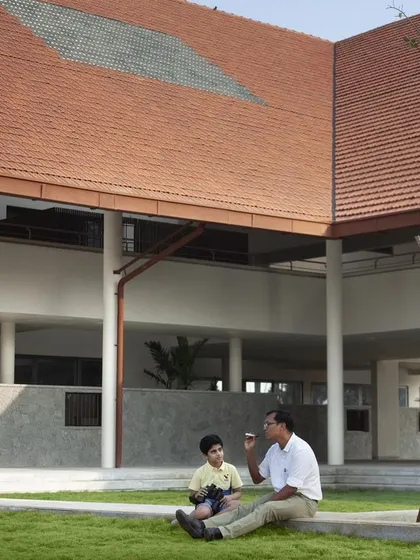 A quiet moment in a courtyard at Vellore International School. The design blurs the line between indoor and outdoor, creating numerous green pockets for both collaborative learning and quiet contemplation.