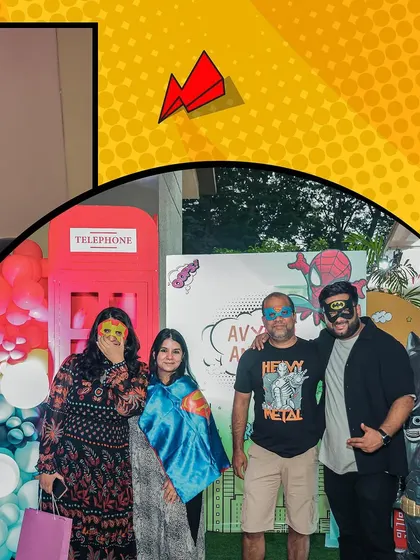 Even the adults get in on the fun! Guests posing with superhero masks and capes at our telephone booth photo op.