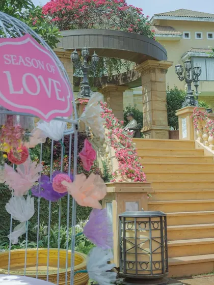 A 'Season of Love' sign inside a decorative birdcage. These small, thoughtful details are scattered throughout the venue to enhance the romantic and whimsical theme.
