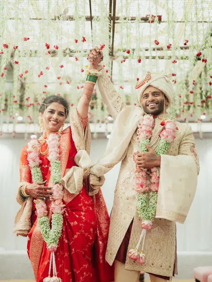 The triumphant couple, hand-in-hand, celebrating their union.