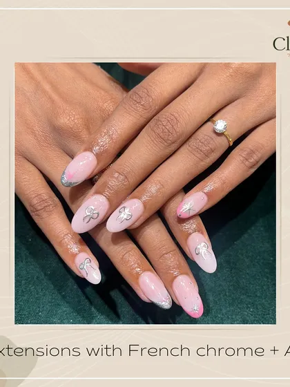The perfect birthday nails. This client celebrated her special day with these beautiful extensions featuring a soft pink base, silver chrome French tips, and adorable 3D silver bows.