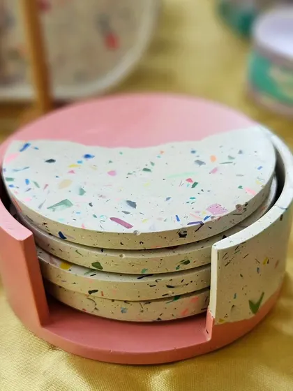 Another view of the terrazzo coaster set, showing how neatly they stack in their custom holder. Each coaster is handmade and one of a kind.