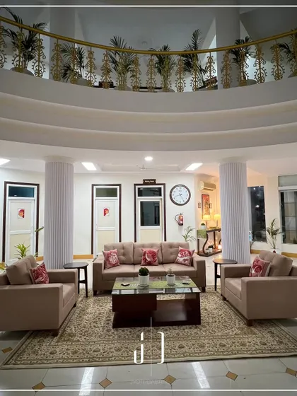 Another angle of the lounge at the Jolly Grant Airport Guest House, showing the balance between open space and cozy seating areas. The design ensures a smooth flow for guests.