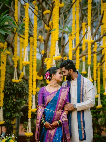 The couple sharing a look of love in front of a stunning marigold backdrop.