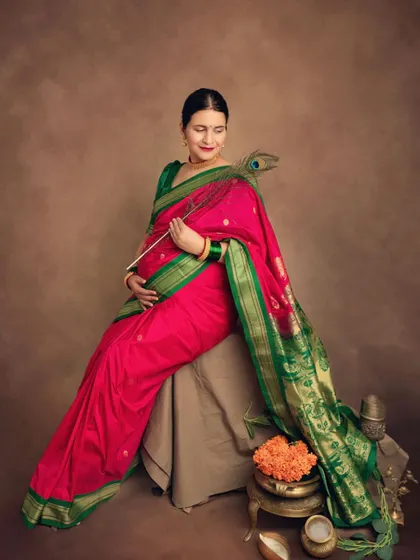 Adding a peacock feather as a prop brings a touch of divine symbolism to this traditional maternity portrait.