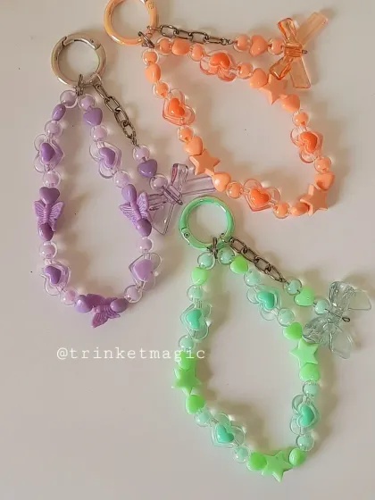 All three of my pastel beaded charms together: purple, orange, and green. They look so cute as a collection and are perfect for mixing and matching.