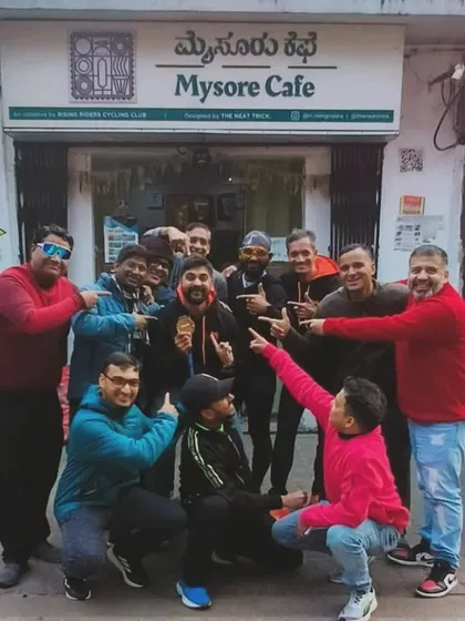 Celebrating a member's 100km ultra run achievement with a group photo at Mysore Cafe. We are each other's biggest cheerleaders.