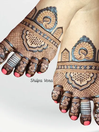 A delicate foot design with peacock motifs and fine line work, perfect for someone who wants an elegant but not overpowering look.