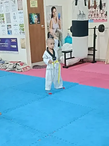 A group of young students practicing their punches with great focus.