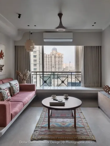 This living room is all about handmade craft. The floating concrete-finish sofa base, custom artwork, and unique rug come together to create a space that feels truly one-of-a-kind.