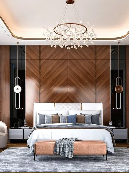 A master bedroom designed for a grand, luxurious feel. The focal point is the wood-paneled wall with black glass inserts and integrated lighting. A large crystal chandelier and a walk-in closet visible to the side complete this opulent and sophisticated space.