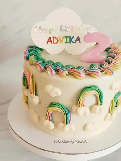 A pretty rainbow themed cake for Advika's second birthday. I used a special piping technique to create the little rainbows all around the cake.