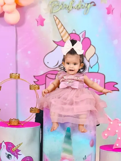 A thrilling 'PJ Masks' themed birthday party, with character cutouts, a cityscape backdrop, and blue and green balloons, ready for a night of adventure.