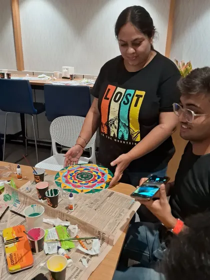 A closer look at me assisting a participant during a Lippan art workshop at SRF Limited. My approach is hands-on, ensuring everyone feels comfortable and confident throughout the creative process.