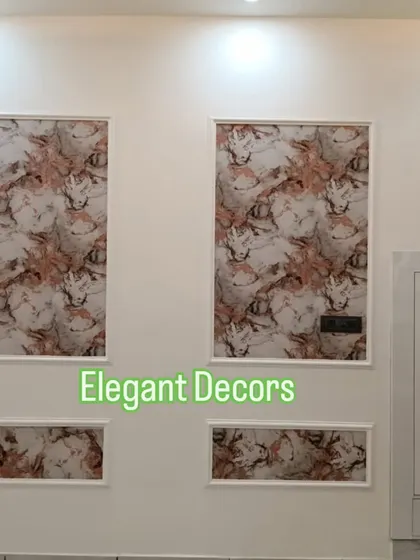 This is another example of using mouldings to create a decorative wall feature. The reddish-toned marble-patterned sheets are framed to look like wall art, adding a touch of color and sophistication to the space.