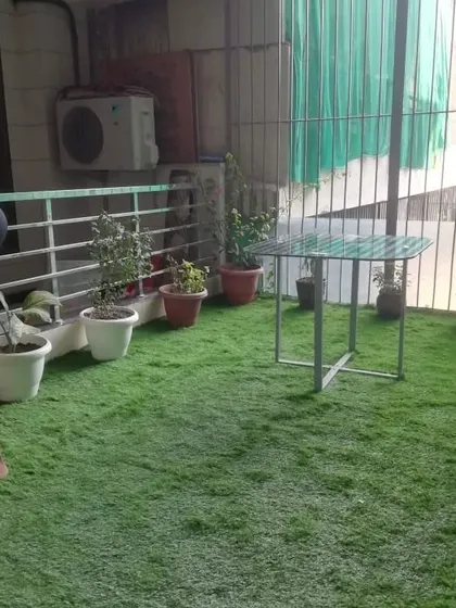 Work in progress at a home in Gurgaon Sector 55. Even with limited space and existing planters, I can lay down artificial grass to create a clean and green floor.