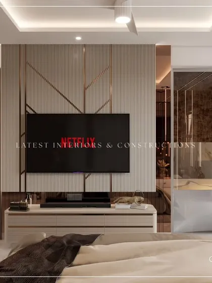The TV panel in this bedroom is a design statement, with geometric metal inlays on a fluted background. This approach turns a functional wall into a piece of art.