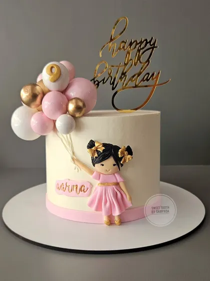 A perfect cake for your little daughter. This chocolate truffle cake for Aarina's 9th birthday features a cute figurine holding a bunch of pink and gold balloons.