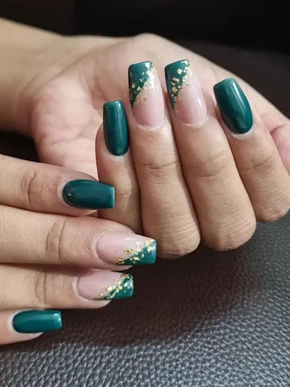 We love adding a touch of luxury with gold foil. This elegant design combines a rich, deep green polish with delicate gold flakes scattered over a natural base for a glamorous look.