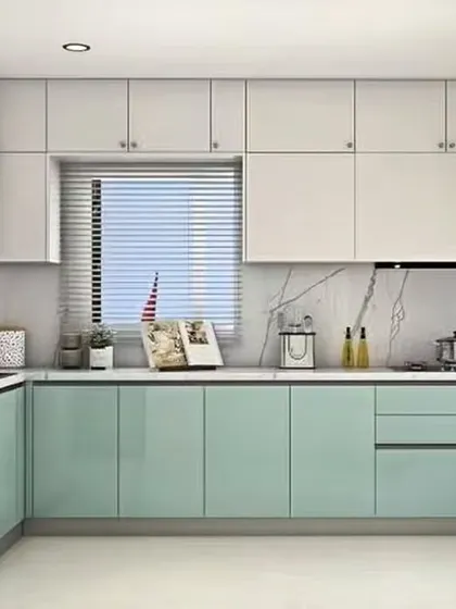 A bright L-shaped kitchen with glossy mint green and white cabinets. The marble-look backsplash adds a touch of luxury to the fresh and modern color scheme.