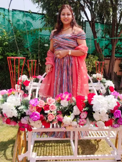 Posing on a beautiful floral-decorated carriage at a Haldi event. The decor was so dreamy and perfect for photos.